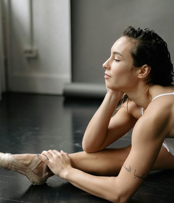 Active woman practicing flexible movements in a minimalist studio setting